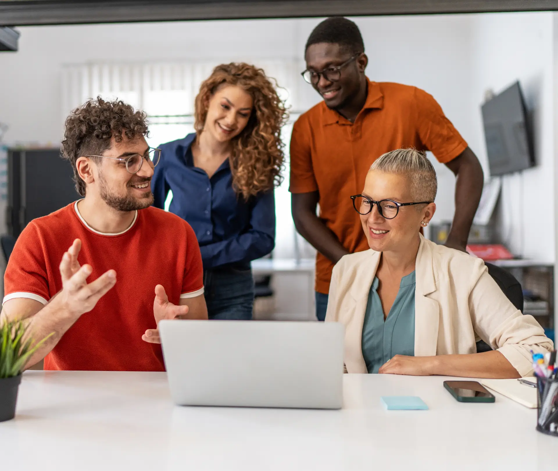 Team discussing project at a laptop