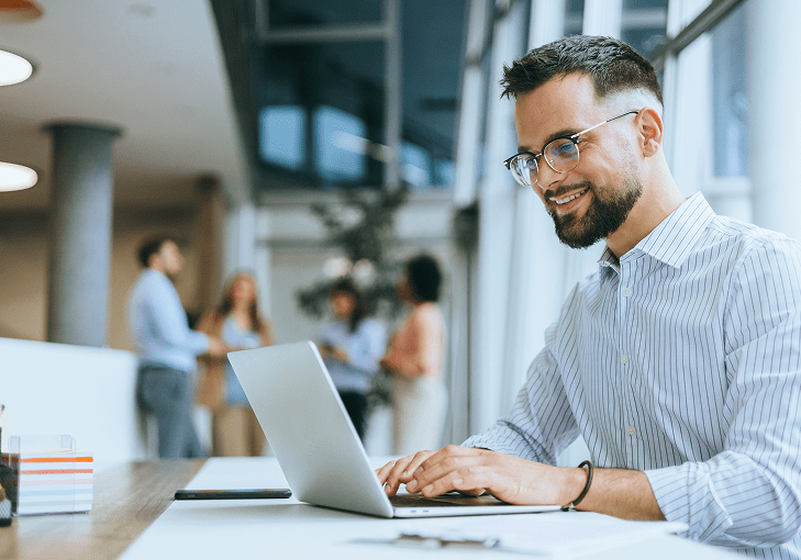 Smiling professional using computer at desk