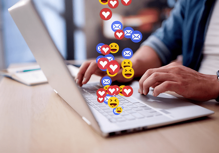 Laptop with animated emojis and messages