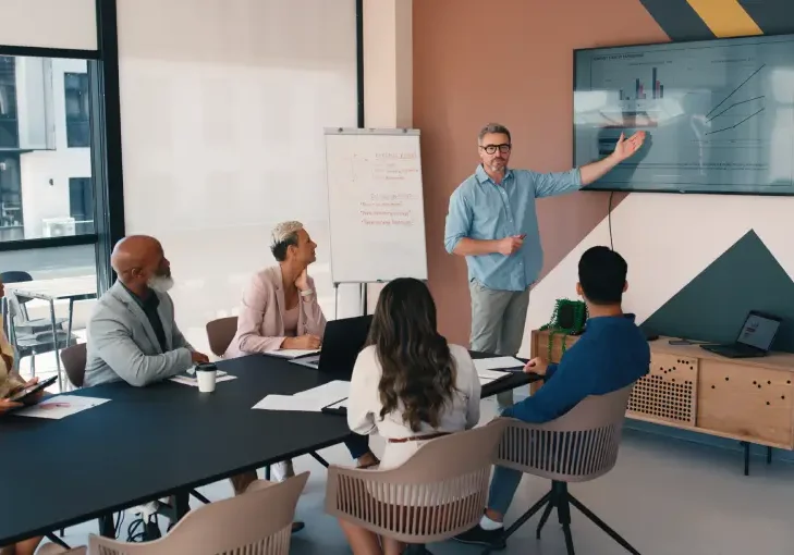 Professional group reviewing graphs on screen
