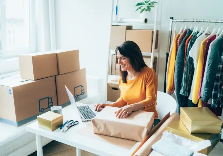 Woman packaging products at home office